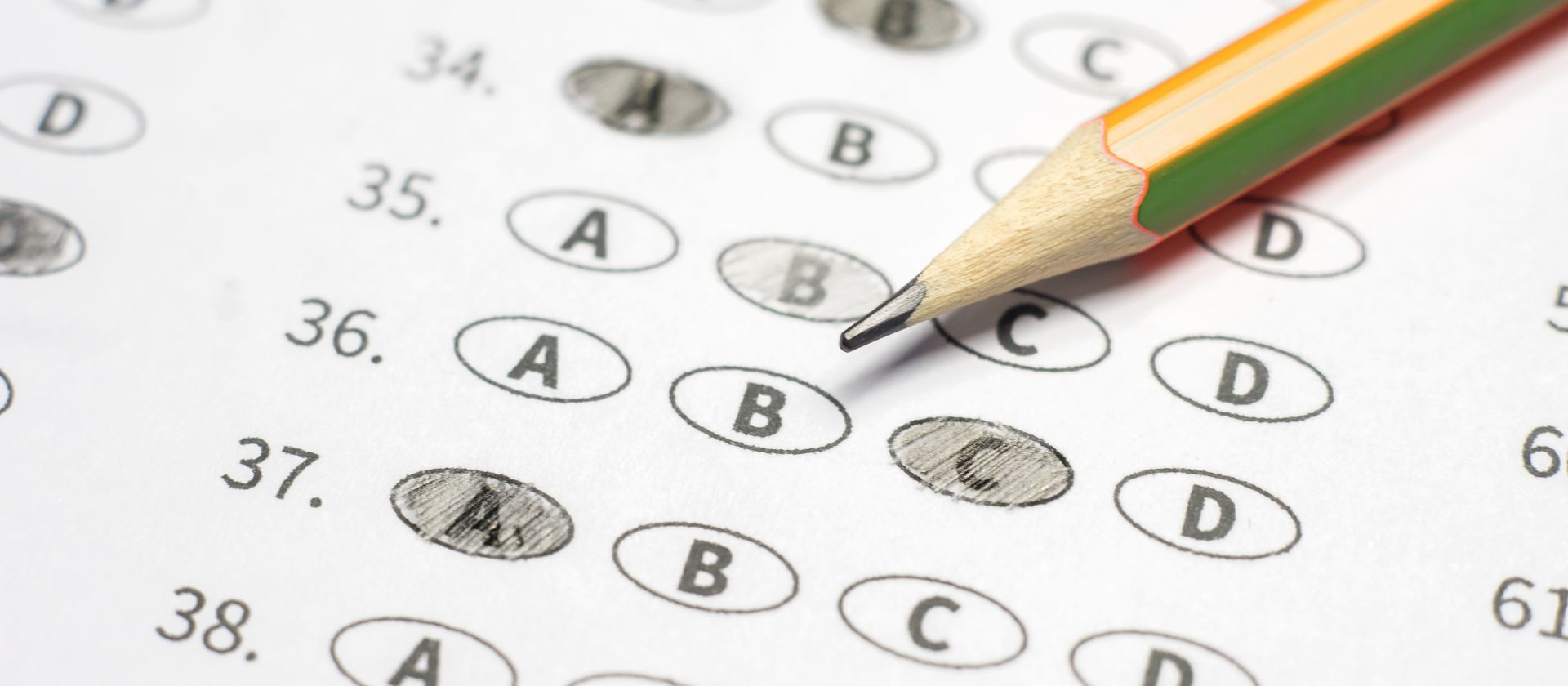 Pencil and Scantron multiple choice form with some bubbles filled in.