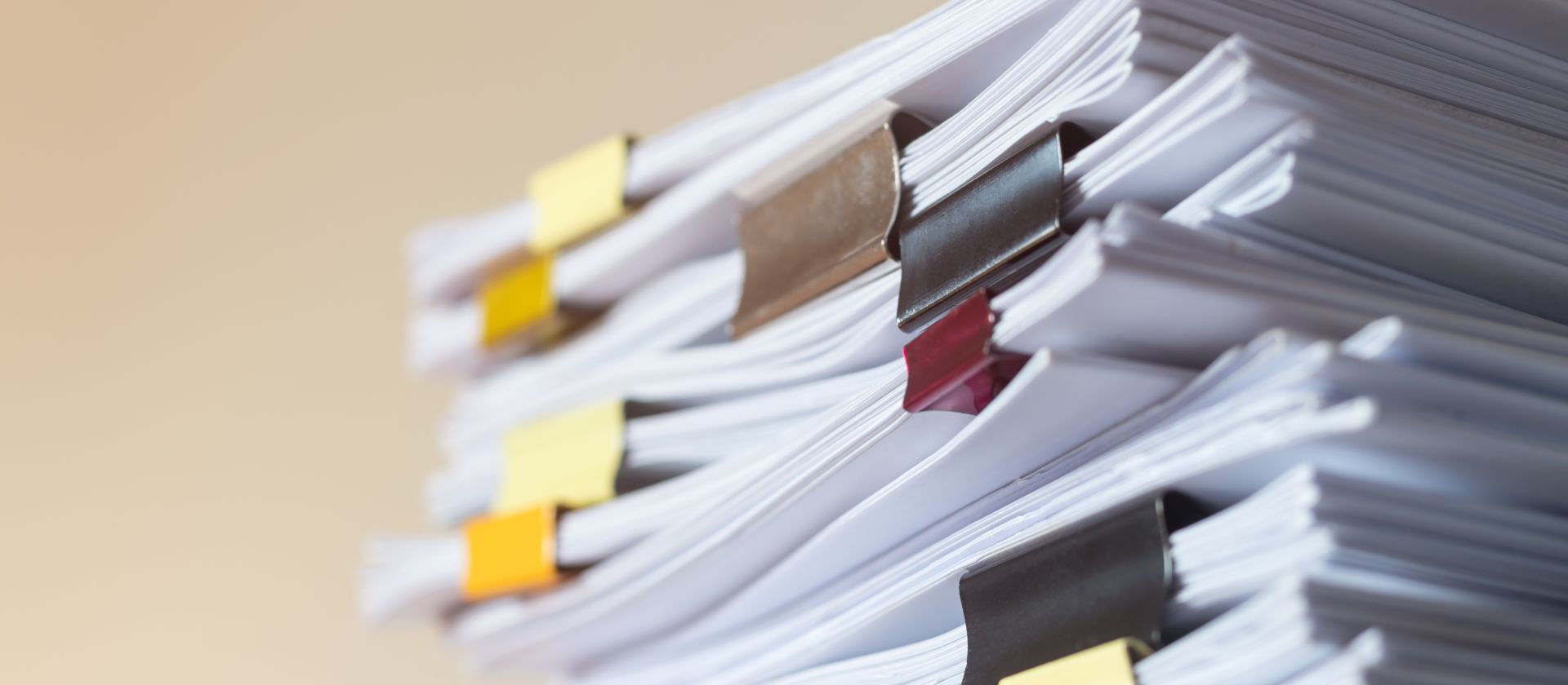 Stack of binder clipped documents.